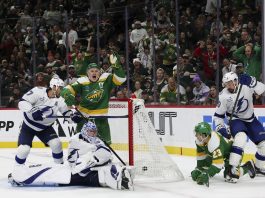 Minnesota Wild left wing Kirill Kaprizov, center left, celebrates as he scores a goal while Tampa Bay Lightning goaltender Andrei Vasilevskiy looks for the puck during the third period of an NHL hockey game, Friday, Nov. 1, 2024, in St. Paul, Minn. (AP Photo/Ellen Schmidt)