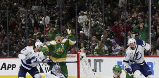 Minnesota Wild left wing Kirill Kaprizov, center left, celebrates as he scores a goal while Tampa Bay Lightning goaltender Andrei Vasilevskiy looks for the puck during the third period of an NHL hockey game, Friday, Nov. 1, 2024, in St. Paul, Minn. (AP Photo/Ellen Schmidt)