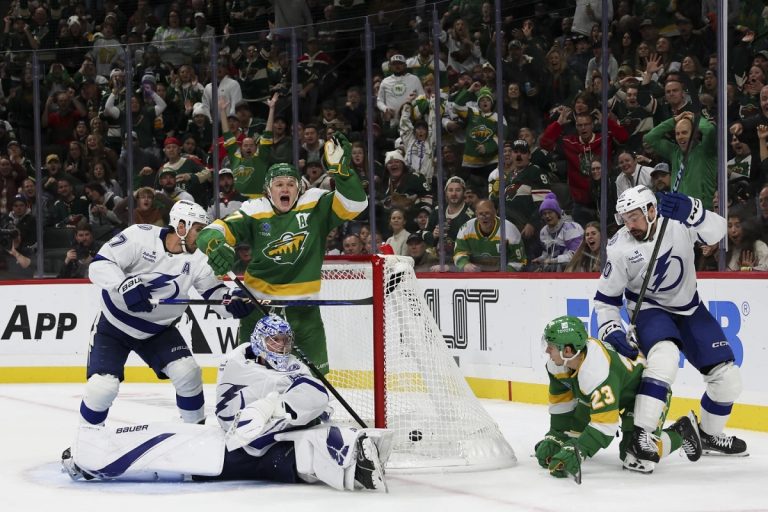 Minnesota Wild left wing Kirill Kaprizov, center left, celebrates as he scores a goal while Tampa Bay Lightning goaltender Andrei Vasilevskiy looks for the puck during the third period of an NHL hockey game, Friday, Nov. 1, 2024, in St. Paul, Minn. (AP Photo/Ellen Schmidt)