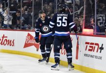 Winnipeg Jets' Mark Scheifele (55) celebrates after his goal against the Tampa Bay Lightning with teammate Gabriel Vilardi (13) during second-period NHL hockey game action in Winnipeg, Manitoba, Sunday, Nov. 3, 2024. (Fred Greenslade/The Canadian Press via AP)