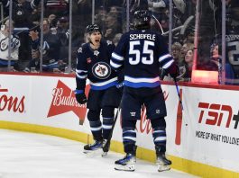 Winnipeg Jets' Mark Scheifele (55) celebrates after his goal against the Tampa Bay Lightning with teammate Gabriel Vilardi (13) during second-period NHL hockey game action in Winnipeg, Manitoba, Sunday, Nov. 3, 2024. (Fred Greenslade/The Canadian Press via AP)