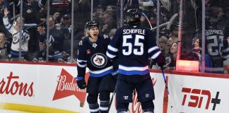 Winnipeg Jets' Mark Scheifele (55) celebrates after his goal against the Tampa Bay Lightning with teammate Gabriel Vilardi (13) during second-period NHL hockey game action in Winnipeg, Manitoba, Sunday, Nov. 3, 2024. (Fred Greenslade/The Canadian Press via AP)