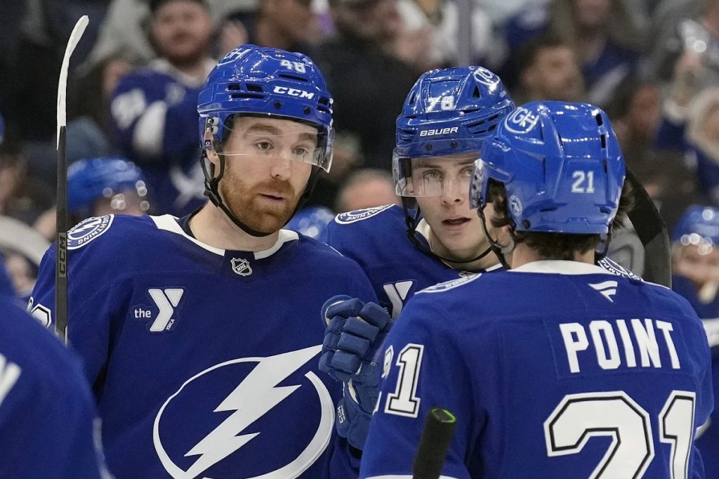 Tampa Bay Lightning defenseman Nick Perbix (48) celebrates his goal against the San Jose Sharks withn defenseman Emil Lilleberg (78) and center Brayden Point (21) during the second period of an NHL hockey game Thursday, Dec. 5, 2024, in Tampa, Fla. (AP Photo/Chris O'Meara)