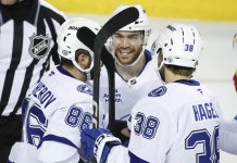 ampa Bay Lightning's Brayden Point, center, celebrates after his goal with teammates during second-period NHL hockey game action against the Calgary Flames in Calgary, Alberta, Thursday, Dec. 12, 2024. (Jeff McIntosh/The Canadian Press via AP)