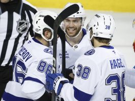 ampa Bay Lightning's Brayden Point, center, celebrates after his goal with teammates during second-period NHL hockey game action against the Calgary Flames in Calgary, Alberta, Thursday, Dec. 12, 2024. (Jeff McIntosh/The Canadian Press via AP)