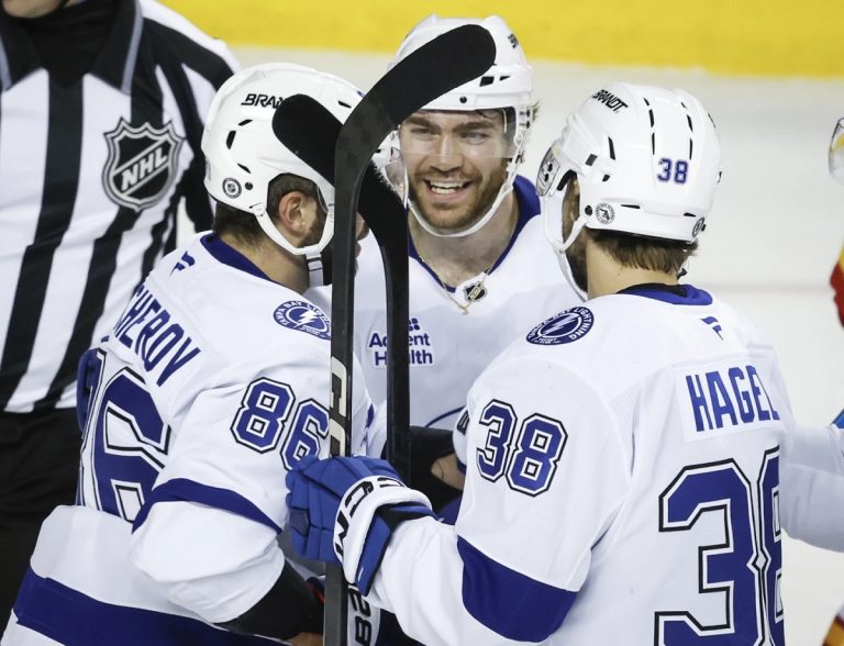 ampa Bay Lightning's Brayden Point, center, celebrates after his goal with teammates during second-period NHL hockey game action against the Calgary Flames in Calgary, Alberta, Thursday, Dec. 12, 2024. (Jeff McIntosh/The Canadian Press via AP)