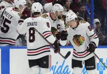 Chicago Blackhawks center Connor Bedard (98) celebrates his goal against the Tampa Bay Lightning with center Ryan Donato (8) during the second period of an NHL hockey game Tuesday, Jan. 28, 2025, in Tampa, Fla. (AP Photo/Chris O'Meara)