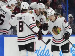 Chicago Blackhawks center Connor Bedard (98) celebrates his goal against the Tampa Bay Lightning with center Ryan Donato (8) during the second period of an NHL hockey game Tuesday, Jan. 28, 2025, in Tampa, Fla. (AP Photo/Chris O'Meara)