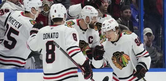 Chicago Blackhawks center Connor Bedard (98) celebrates his goal against the Tampa Bay Lightning with center Ryan Donato (8) during the second period of an NHL hockey game Tuesday, Jan. 28, 2025, in Tampa, Fla. (AP Photo/Chris O'Meara)