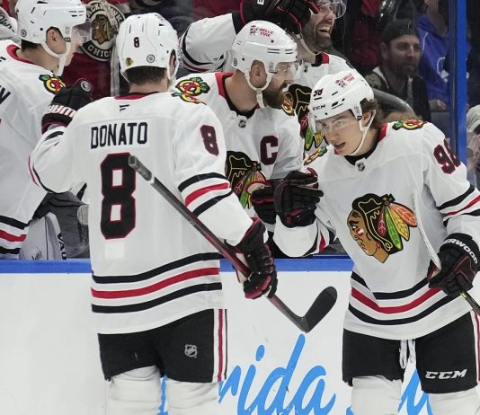 Chicago Blackhawks center Connor Bedard (98) celebrates his goal against the Tampa Bay Lightning with center Ryan Donato (8) during the second period of an NHL hockey game Tuesday, Jan. 28, 2025, in Tampa, Fla. (AP Photo/Chris O'Meara)