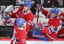 Montreal Canadiens' Jake Evans (71) celebrates with teammates Kirby Dach (77) and Patrik Laine (92) after scoring against the Tampa Bay Lightning during third period NHL hockey action in Montreal, Tuesday, January 21, 2025. (Graham Hughes/The Canadian Press via AP)