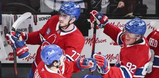 Montreal Canadiens' Jake Evans (71) celebrates with teammates Kirby Dach (77) and Patrik Laine (92) after scoring against the Tampa Bay Lightning during third period NHL hockey action in Montreal, Tuesday, January 21, 2025. (Graham Hughes/The Canadian Press via AP)