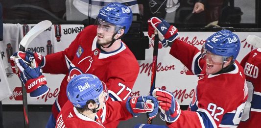 Montreal Canadiens' Jake Evans (71) celebrates with teammates Kirby Dach (77) and Patrik Laine (92) after scoring against the Tampa Bay Lightning during third period NHL hockey action in Montreal, Tuesday, January 21, 2025. (Graham Hughes/The Canadian Press via AP)