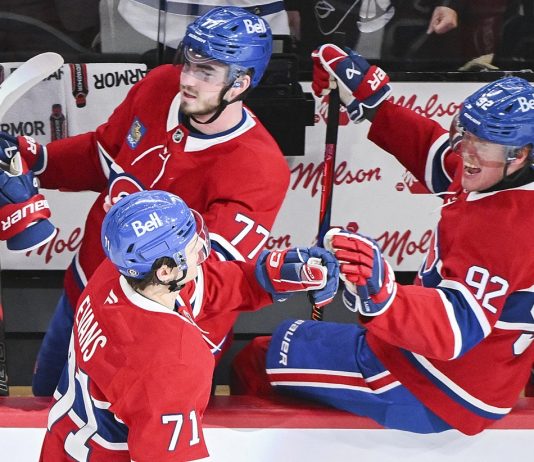 Montreal Canadiens' Jake Evans (71) celebrates with teammates Kirby Dach (77) and Patrik Laine (92) after scoring against the Tampa Bay Lightning during third period NHL hockey action in Montreal, Tuesday, January 21, 2025. (Graham Hughes/The Canadian Press via AP)