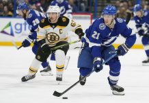 Tampa Bay Lightning center Brayden Point (21) breaks out ahead of Boston Bruins left wing Brad Marchand (63) during the second period of an NHL hockey game Thursday, Jan. 9, 2025, in Tampa, Fla. (AP Photo/Chris O'Meara)