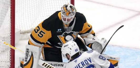 Pittsburgh Penguins goaltender Tristan Jarry (35) blocks a shot by Tampa Bay Lightning's Nikita Kucherov (86) during the first period of an NHL hockey game in Pittsburgh, Sunday, Jan. 12, 2025. (AP Photo/Gene J. Puskar)