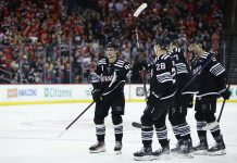 New Jersey Devils center Jack Hughes (86) celebrates with teammates after scoring a goal against the Tampa Bay Lightning during the second period of an NHL hockey game, Saturday, Jan. 11, 2025, in Newark, N.J. (AP Photo/Noah K. Murray)