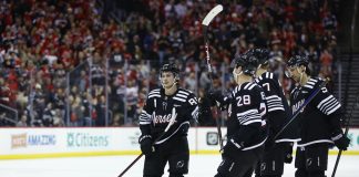 New Jersey Devils center Jack Hughes (86) celebrates with teammates after scoring a goal against the Tampa Bay Lightning during the second period of an NHL hockey game, Saturday, Jan. 11, 2025, in Newark, N.J. (AP Photo/Noah K. Murray)