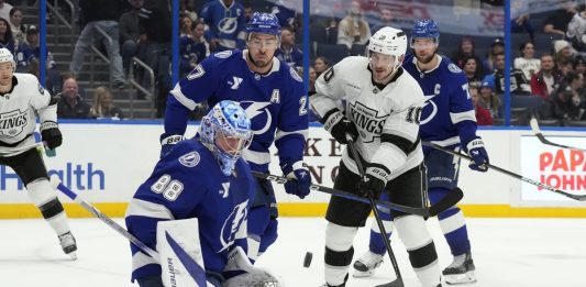 Tampa Bay Lightning goaltender Andrei Vasilevskiy (88) makes a save on a deflection by Los Angeles Kings left wing Tanner Jeannot (10) in front of defenseman Ryan McDonagh (27) during the third period of an NHL hockey game Thursday, Jan. 30, 2025, in Tampa, Fla. (AP Photo/Chris O'Meara)