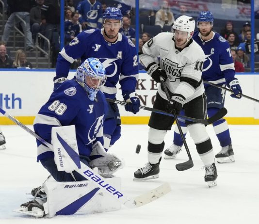 Tampa Bay Lightning goaltender Andrei Vasilevskiy (88) makes a save on a deflection by Los Angeles Kings left wing Tanner Jeannot (10) in front of defenseman Ryan McDonagh (27) during the third period of an NHL hockey game Thursday, Jan. 30, 2025, in Tampa, Fla. (AP Photo/Chris O'Meara)