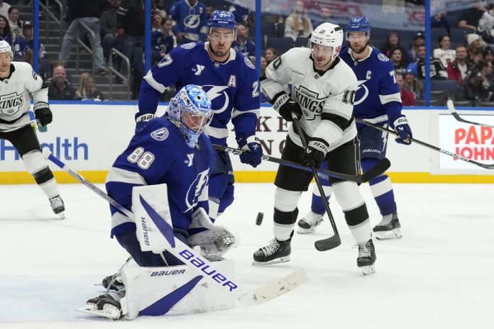 Tampa Bay Lightning goaltender Andrei Vasilevskiy (88) makes a save on a deflection by Los Angeles Kings left wing Tanner Jeannot (10) in front of defenseman Ryan McDonagh (27) during the third period of an NHL hockey game Thursday, Jan. 30, 2025, in Tampa, Fla. (AP Photo/Chris O'Meara)