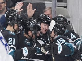 San Jose Sharks center Tyler Toffoli, center, celebrates with teammates after scoring a gaol against the Tampa Bay Lightning during the first period of an NHL hockey game in San Jose, Calif., Thursday, Jan. 2, 2025. (AP Photo/Tony Avelar)