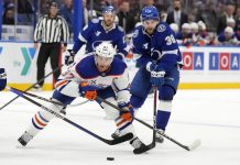 Edmonton Oilers center Connor McDavid (97) gets around Tampa Bay Lightning left wing Brandon Hagel (38) during the third period of an NHL hockey game Tuesday, Feb. 25, 2025, in Tampa, Fla. (AP Photo/Chris O'Meara)