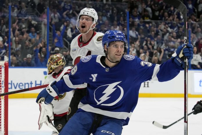 Tampa Bay Lightning left wing Brandon Hagel (38) celebrates in front of Ottawa Senators defenseman Thomas Chabot (72) after scoring past goaltender Anton Forsberg during the second period of an NHL hockey game Thursday, Feb. 6, 2025, in Tampa, Fla. (AP Photo/Chris O'Meara)