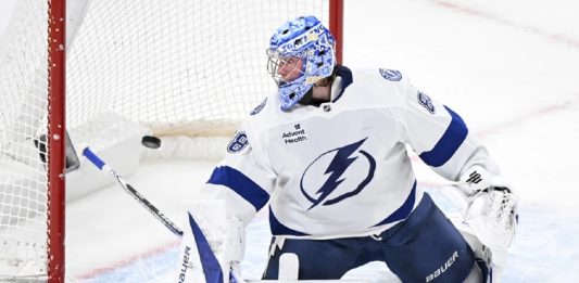 Tampa Bay Lightning goaltender Andrei Vasilevskiy is scored against by Montreal Canadiens' Brendan Gallagher during first-period NHL hockey game action in Montreal, Sunday, Feb. 9, 2025. (Graham Hughes/The Canadian Press via AP)