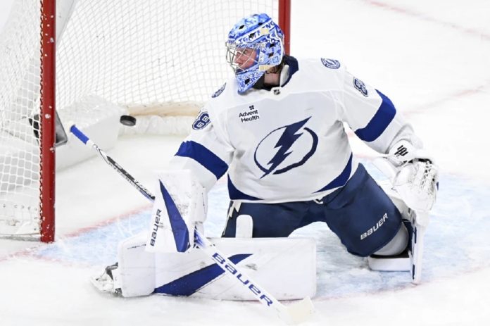 Tampa Bay Lightning goaltender Andrei Vasilevskiy is scored against by Montreal Canadiens' Brendan Gallagher during first-period NHL hockey game action in Montreal, Sunday, Feb. 9, 2025. (Graham Hughes/The Canadian Press via AP)