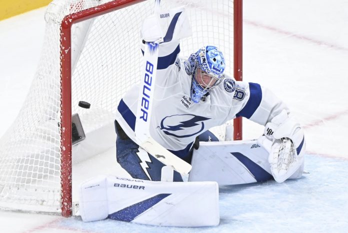 Tampa Bay Lightning goaltender Andrei Vasilevskiy is scored on by Montreal Canadiens' Jake Evans during third period NHL hockey action in Montreal, Tuesday, Jan. 21, 2025. (Graham Hughes/The Canadian Press via AP)