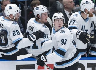 Utah Hockey Club's Logan Cooley (92) celebrates after his goal against the Vancouver Canucks with teammates during the third period of an NHL hockey game in Vancouver, British Columbia, Sunday, March 16, 2025. (Ethan Cairns/The Canadian Press via AP)