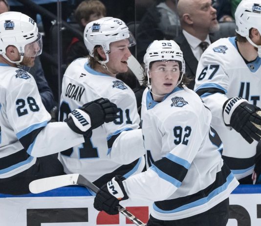 Utah Hockey Club's Logan Cooley (92) celebrates after his goal against the Vancouver Canucks with teammates during the third period of an NHL hockey game in Vancouver, British Columbia, Sunday, March 16, 2025. (Ethan Cairns/The Canadian Press via AP)