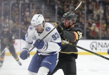 Vegas Golden Knights right wing Victor Olofsson (95) pushes Tampa Bay Lightning center Gage Goncalves (93) during the first period of an NHL hockey game Sunday, March 23, 2025, in Las Vegas. (AP Photo/Ian Maule)