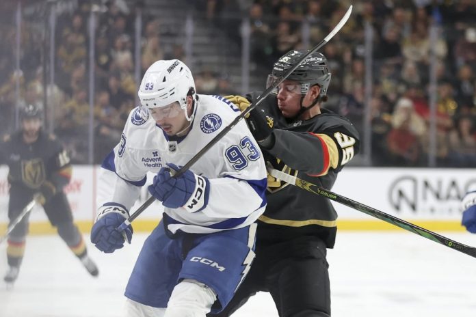Lightnig Fall To Vegas Vegas Golden Knights right wing Victor Olofsson (95) pushes Tampa Bay Lightning center Gage Goncalves (93) during the first period of an NHL hockey game Sunday, March 23, 2025, in Las Vegas. (AP Photo/Ian Maule)