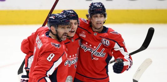 Washington Capitals left wing Alex Ovechkin (8) celebrates his goal with center Dylan Strome (17) and defenseman Martin Fehervary (42) during the third period of an NHL hockey game against the Tampa Bay Lightning, Saturday, March 1, 2025, in Washington. (AP Photo/Nick Wass)