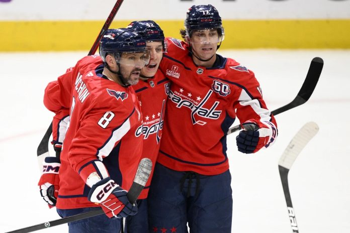 Washington Capitals left wing Alex Ovechkin (8) celebrates his goal with center Dylan Strome (17) and defenseman Martin Fehervary (42) during the third period of an NHL hockey game against the Tampa Bay Lightning, Saturday, March 1, 2025, in Washington. (AP Photo/Nick Wass)