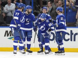 Tampa Bay Lightning right wing Nikita Kucherov (86) celebrates his power-play goal against the Calgary Flames with defenseman Victor Hedman (77), left wing Brandon Hagel (38), center Jake Guentzel (59), and center Brayden Point (21) during the first period of an NHL hockey game Thursday, Feb. 27, 2025, in Tampa, Fla. (AP Photo/Chris O'Meara)