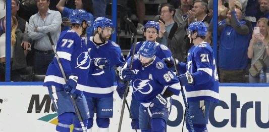 Tampa Bay Lightning right wing Nikita Kucherov (86) celebrates his power-play goal against the Calgary Flames with defenseman Victor Hedman (77), left wing Brandon Hagel (38), center Jake Guentzel (59), and center Brayden Point (21) during the first period of an NHL hockey game Thursday, Feb. 27, 2025, in Tampa, Fla. (AP Photo/Chris O'Meara)