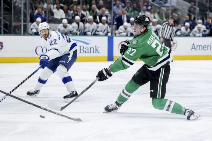 Dallas Stars left wing Mason Marchment (27) shoots during an NHL hockey game against the Tampa Bay Lightning in Dallas, Thursday, March 20, 2025. (AP Photo/Gareth Patterson)