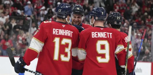 Florida Panthers center Aleksander Barkov (16) is congratulated after scoring a goal during the second period of an NHL hockey game against the Tampa Bay Lightning Monday, March 3, 2025, in Sunrise, Fla. (AP Photo/Lynne Sladky)