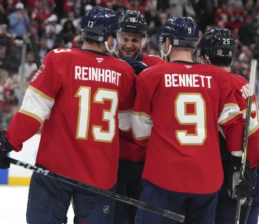 Florida Panthers center Aleksander Barkov (16) is congratulated after scoring a goal during the second period of an NHL hockey game against the Tampa Bay Lightning Monday, March 3, 2025, in Sunrise, Fla. (AP Photo/Lynne Sladky)