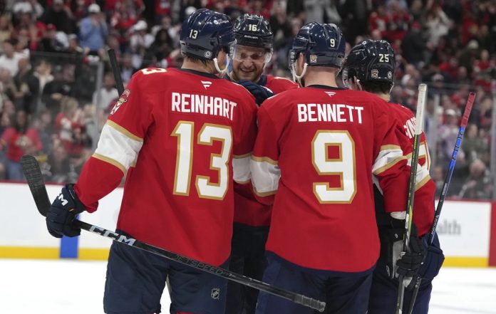 Florida Panthers center Aleksander Barkov (16) is congratulated after scoring a goal during the second period of an NHL hockey game against the Tampa Bay Lightning Monday, March 3, 2025, in Sunrise, Fla. (AP Photo/Lynne Sladky)