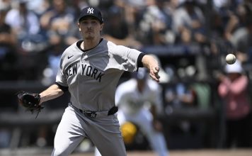 New York Yankees starting pitcher Max Fried throws to first base on a pick-off attempt as Tampa Bay Rays' Junior Caminero makes it back safely during the first inning of a baseball game, Sunday, April 20, 2025, in Tampa, Fla. (AP Photo/Phelan M. Ebenhack)