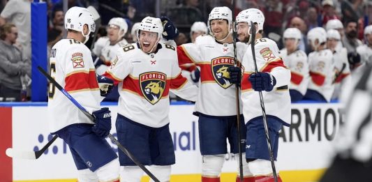 Florida Panthers defenseman Nate Schmidt (88) celebrates his goal against the Tampa Bay Lightning with center Aleksander Barkov (16), Sam Reinhart (13) and Uvis Balinskis (26) during the first period in Game 2 of an NHL hockey Stanley Cup first-round playoff series, Thursday, April 24, 2025, in Tampa, Fla. (AP Photo/Chris O'Meara)