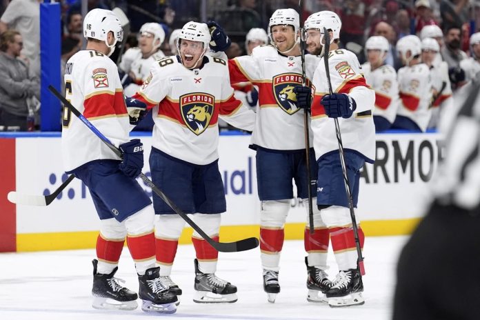 Florida Panthers defenseman Nate Schmidt (88) celebrates his goal against the Tampa Bay Lightning with center Aleksander Barkov (16), Sam Reinhart (13) and Uvis Balinskis (26) during the first period in Game 2 of an NHL hockey Stanley Cup first-round playoff series, Thursday, April 24, 2025, in Tampa, Fla. (AP Photo/Chris O'Meara)