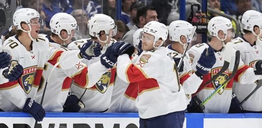 Florida Panthers left wing Matthew Tkachuk (19) celebrates with the bench after scoring against the Tampa Bay Lightning during the second period in Game 1 of an NHL hockey Stanley Cup first-round playoff series, Tuesday, April 22, 2025, in Tampa, Fla. (AP Photo/Chris O'Meara)