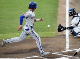 Kansas City Royals' Drew Waters scores ahead of the throw to Tampa Bay Rays catcher Ben Rortvedt (30) on a sacrifice,fly by Kyle Isbel during the second inning of a baseball game Tuesday, April 29, 2025, in Tampa, Fla. (AP Photo/Chris O'Meara)