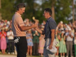 Rory McIlroy, of Northern Ireland, right, greets Justin Rose, of England, after winning in a playoff after the final round the Masters golf tournament, Sunday, April 13, 2025, in Augusta, Ga. (AP Photo/Matt Slocum)