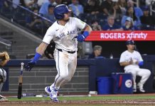 Toronto Blue Jays third baseman Addison Barger runs out a single against the Tampa Bay Rays in fifth inning baseball action in Toronto on Wednesday, May 14, 2025. (Jon Blacker/The Canadian Press via AP)